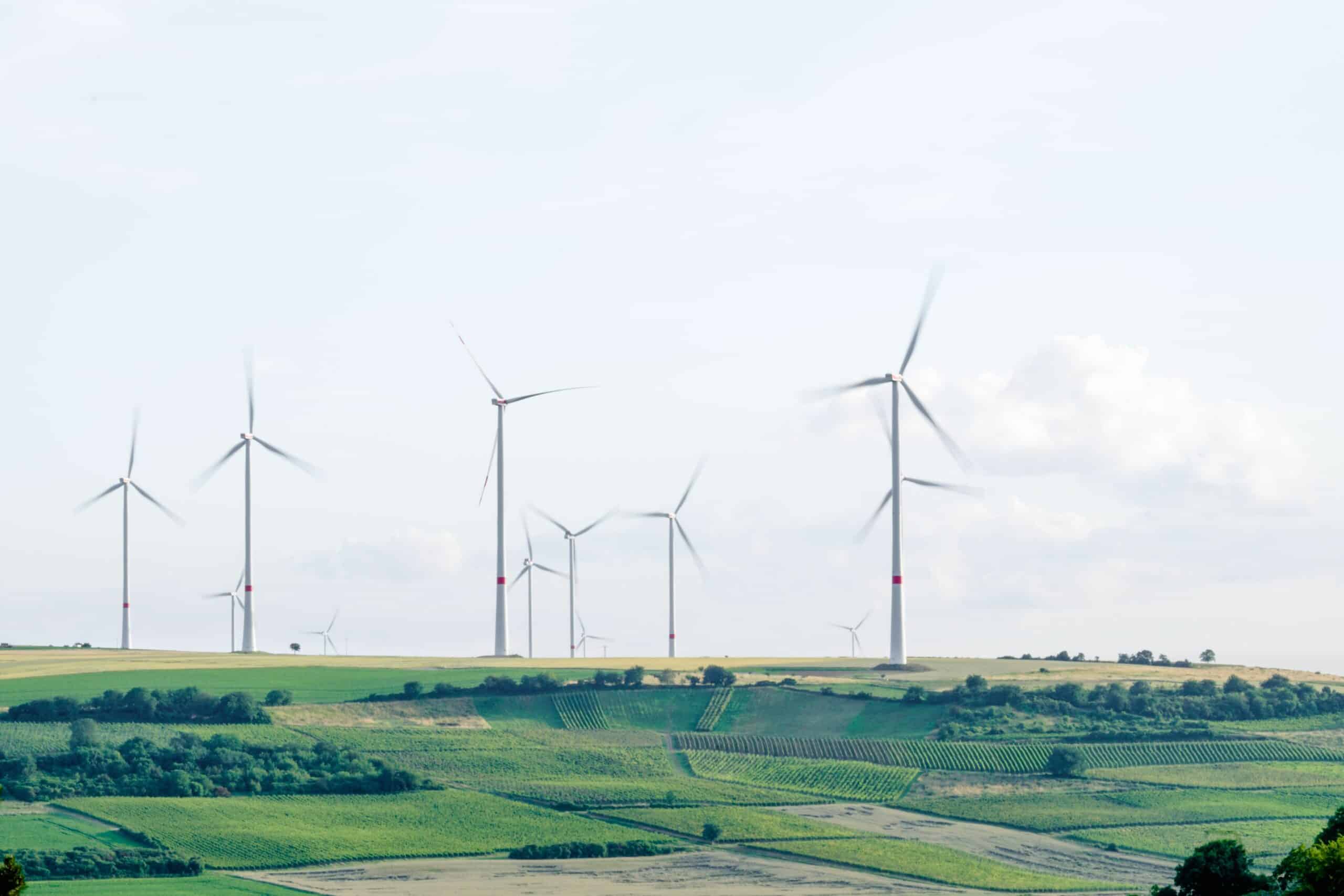 wind turbines in lush green field environmental IoT improves sustainability